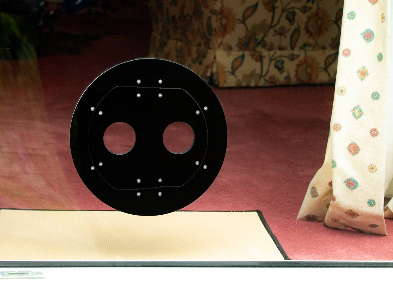 A black Petflap draughtproof pet door set into a patio window.