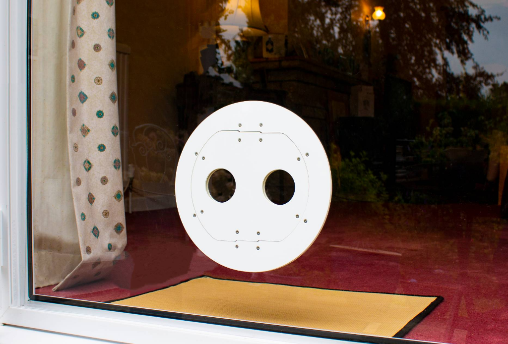 A white Petflap draughtproof pet door set into a patio window